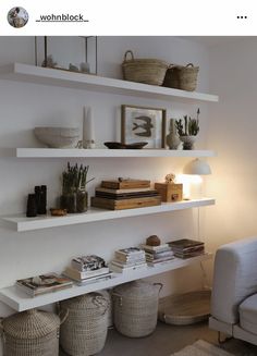 a living room filled with lots of white shelves