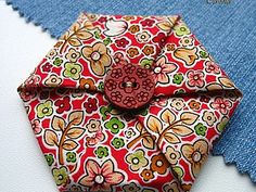 an origami flowered tie with a wooden button on it