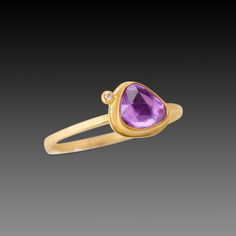 This gorgeous ring features a lavender-pink, rose cut sapphire wrapped in warm 22k gold, and accented with a single sparkling diamond. This ring is lovely on its own, and stacks beautifully with others in the collection. The setting measures approximately 6.5mm x 7.5mm. 18k gold 1.5mm, hammered band. Matte finish. Yellow Gold Rings With Pink Sapphire And Gemstone Accents, Yellow Gold Diamond Ring With Rose Cut Pink Sapphire, Gold Rings With Rose Cut Diamonds And Pink Sapphire, Gold Amethyst Rings With Rose Cut Diamonds, Gold Jewelry With Rose Cut Diamonds And Pink Sapphire, Yellow Gold Pink Sapphire Rings With Single Cut Diamonds, Gold Pink Sapphire Ring With Bezel Setting, December Gift, Hand Painted Gifts