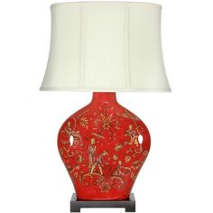 a red vase lamp with a white shade on the bottom and an ornate design on the base