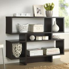 a modern book shelf with books and vases on it