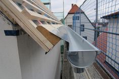 a metal roof vent on the side of a building