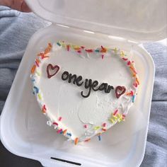 a heart shaped cake with the word one year written on it