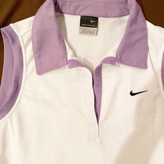 Never Worn Nike Sphere Dry White Tennis Shirt. Sleeveless White With Violet Collar And Outline Sleeves. 100% Polyester Sleeveless Cotton Nike Top, Nike Sleeveless Summer Tops, Nike Sleeveless Tops For Summer, White Golf Top For Spring, White Golf Tops For Spring, White Tops For Golf In Spring, Nike Purple Sleeveless Tops, Casual Nike Golf Tops, Tennis Shirt