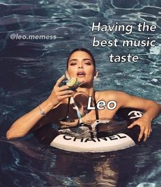 a woman sitting on top of a surfboard in the water drinking from a bottle