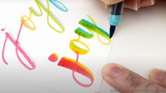 someone is drawing with colored crayons on paper and writing the word do it yourself