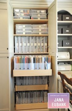 an organized pantry with clear plastic containers and file folders on the bottom shelf, next to a wooden chair