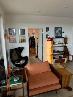 a living room filled with furniture and pictures on the wall