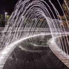 water spouting from the ground at night