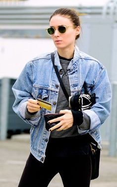 a woman in black pants and a jean jacket