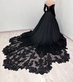 a black wedding dress on display in a room