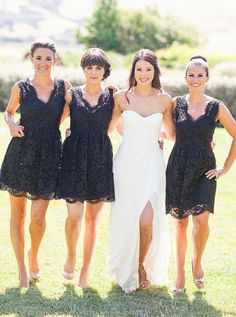 four bridesmaids in black dresses posing for the camera