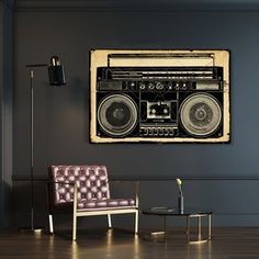 an old fashioned radio is hanging on the wall next to a purple chair and lamp