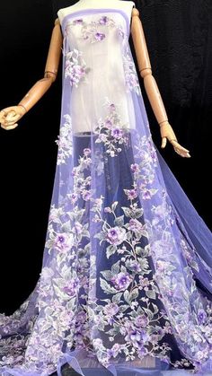 a mannequin wearing a purple dress with flowers on it