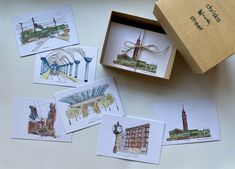 six greeting cards in a gift box with artwork on the front and inside, including an image of a clock tower