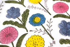 an image of colorful flowers on white fabric