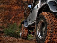 a jeep parked in front of a cliff