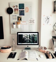 a white desk topped with a computer monitor and keyboard