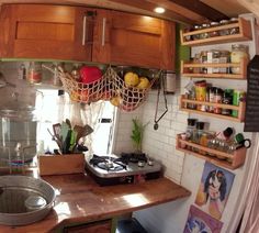 a small kitchen with wooden cabinets and shelves