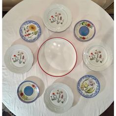 a white table topped with lots of plates