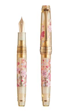 two pens with flowers on them sitting next to each other