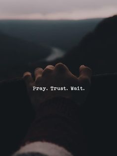 someone is holding their hand up to the camera with text overlaying them that reads pray trust wait