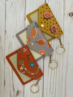 We love our new Colorful Hand Painted Keychain Wallet.  Mini Boho Wallets are compact but surprisingly spacious and are designed for the girl who likes to love unencumbered and carefree. They are easily transferred from one purse to another, and the small size makes it perfect to put them in your pockets. Material: Faux Leather.  Color: Orange, Light Purple, & Yellow  Ladies compartment wallet 1 Credit card slots 1 Interior  zip pocket 1 Gold Keychain  Dimensions: 4.25" x 3" Check out other simi Cheap Trendy Multicolor Wallets, Cheap Playful Multicolor Wallets, Playful Multicolor Cheap Wallets, Painted Keychain, Miyuki Ring, Key Chain Wallet, Paint Keys, Boho Wallet, Unique Wallets