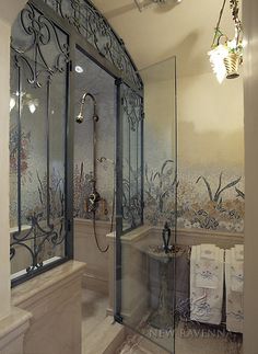 a bathroom with a walk in shower next to a sink and toilet paper on the counter