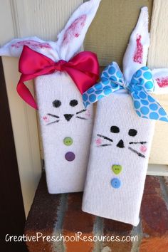 two towels decorated to look like rabbits are hanging on the front door with a bow