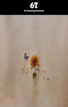 the back of a woman's stomach with a sunflower and butterfly on it