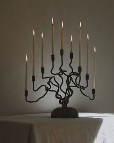 a candle holder with many lit candles in it