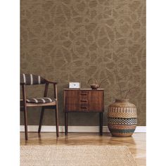 two chairs and a table in front of a wall with a brown pattern on it