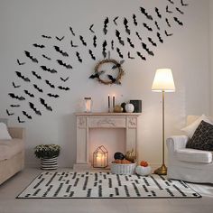 a living room decorated in black and white with lots of bats on the wall above it