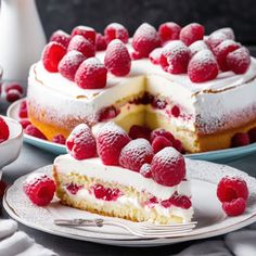 a piece of cake with raspberries is on a plate next to the rest of the cake