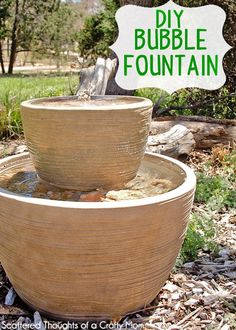 there is a fountain made out of wood in the yard with text overlay that reads diy bubble fountain