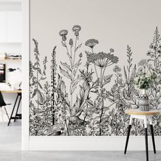 a wall mural with black and white flowers on it