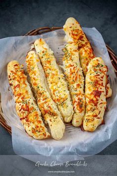 bread sticks with cheese and herbs in a wicker basket