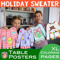 two girls holding up christmas sweaters in front of a book shelf with other children's clothing on it