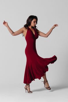 a woman in a red dress is dancing