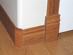 an open refrigerator door on the side of a wooden floor