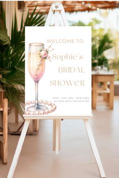 a welcome sign for a bridal shower is displayed on an easel with pearls