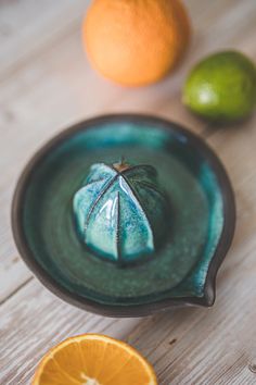 an orange sitting on top of a wooden table