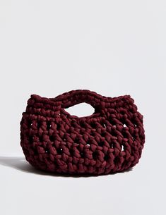 a crocheted bag sitting on top of a white surface