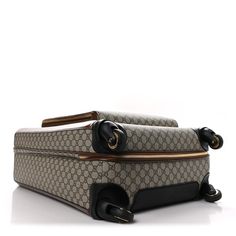 This is an authentic GUCCI GG Supreme Monogram Azalea Calfskin Retro Interlocking G Carry On Trolley in Beige, Ebony, and Brown Sugar. This chic luggage is crafted of Gucci GG supreme monogram canvas. The bag features leather trim, a retractable top handle, side handles, and opens to a spacious ivory fabric interior with elastic straps and a zipper pocket. For added utility, this suitcase features 360-degree wheels. Ivory Fabric, Leather Trim, Monogram Canvas, 360 Degree, Leather Trims, Brown Sugar, Top Handle, Zipper Pocket, Carry On