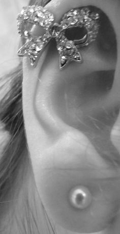 a close up of a person's ear with a bow on it