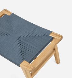 a wooden chair with blue fabric on it