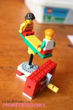 a lego man sitting on top of a red bench next to a white and yellow object