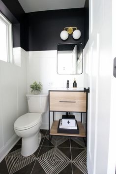 a white toilet sitting in a bathroom next to a wooden shelf with a potted plant on it