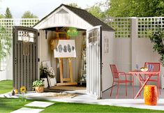 a small garden shed with the door open to reveal an outdoor dining area and table