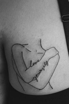 a woman's stomach with the words love yourself tattooed on her left side ribcage